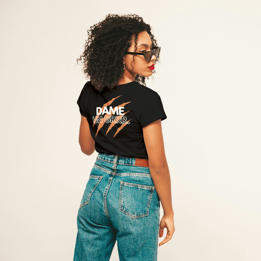 Model wearing black unisex T-shirt 'DAME UN GRRR' with stylish back design made of eco-friendly cotton.